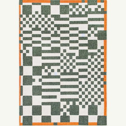 Louis De Poortere Chess rug featuring geometric black and white patterns with orange border luxury rug