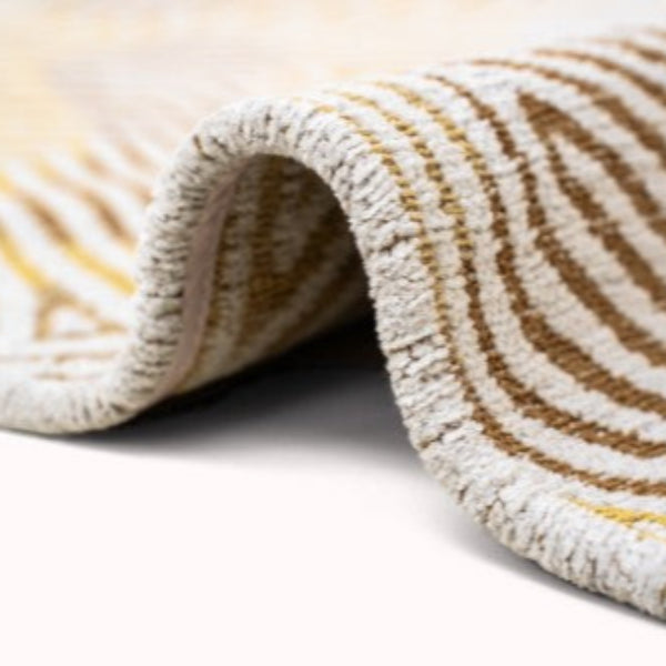 Close-up of the textured edge and wave pattern on the Louis De Poortere Coral rug showcasing luxury craftsmanship