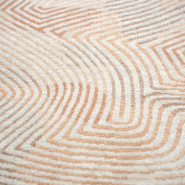 Close-up of Louis De Poortere Coral rug showing luxury design with coral and cream geometric patterns