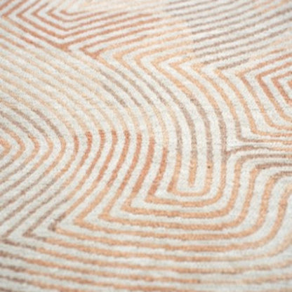 Close-up of Louis De Poortere Coral rug showing luxury design with coral and cream geometric patterns