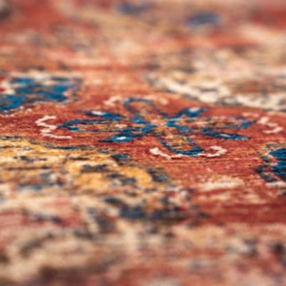 Close-up of a detailed patterned luxury Louis De Poortere Kasak rug with rich red and blue colours