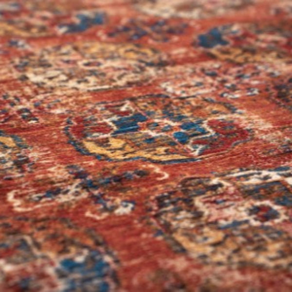 Close-up view of luxury Louis De Poortere Kasak rug with intricate red, blue, and beige patterns