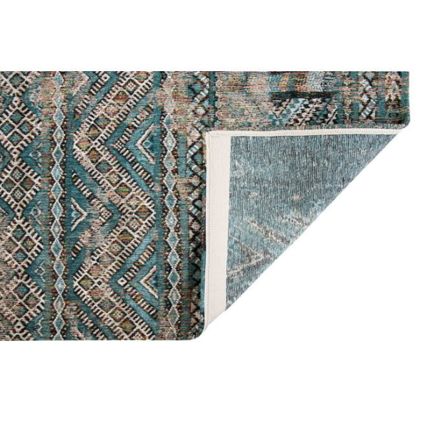Close-up of a luxury Louis De Poortere kilim rug with intricate geometric patterns in blue and beige tones