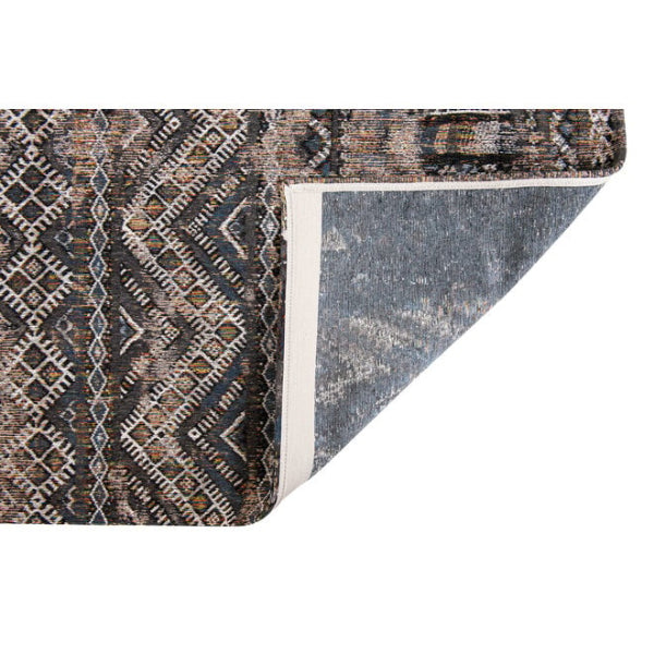 Close-up of Louis De Poortere kilim rug showing intricate geometric patterns and folded corner