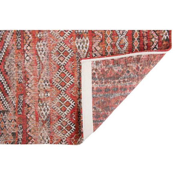 Close-up of a luxury Louis De Poortere kilim rug with intricate red and earth tone geometric patterns
