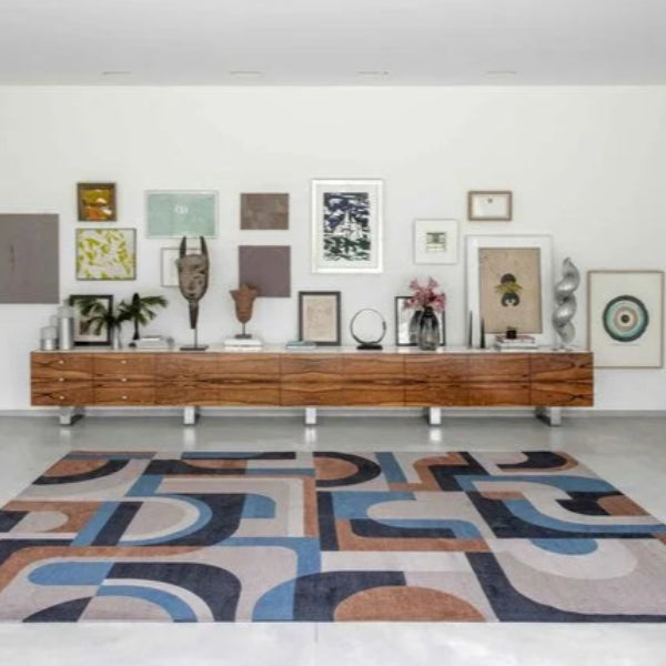 Modern living room with a Louis De Poortere Module rug featuring abstract geometric patterns in blue, black, and brown