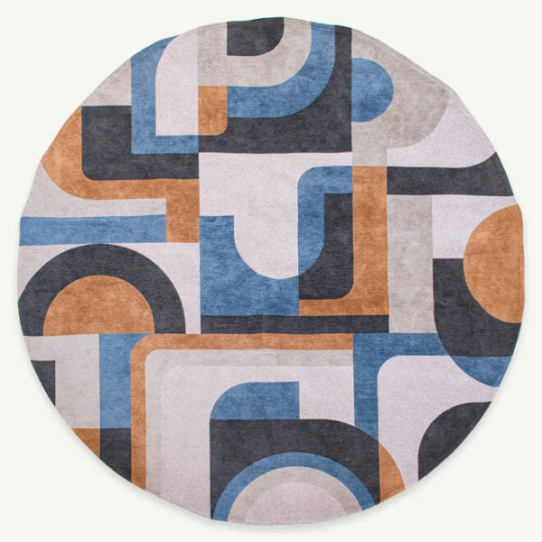 Round Louis De Poortere Module rug with abstract geometric pattern in blue grey and brown tones