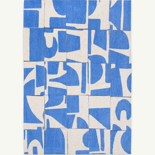 Louis De Poortere Papercut rug featuring abstract blue and white geometric patterns in a luxury design