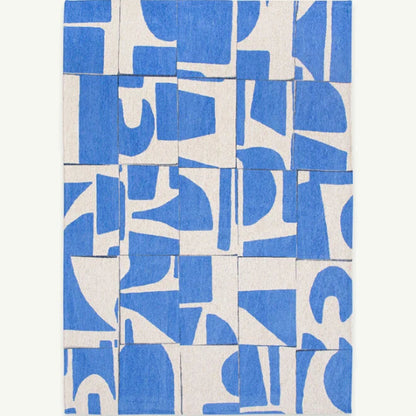 Louis De Poortere Papercut rug featuring abstract blue and white geometric patterns in a luxury design