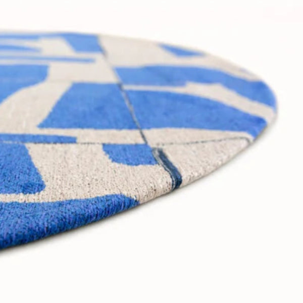 Close-up of a blue and beige Louis De Poortere Papercut rug showing detailed texture and pattern