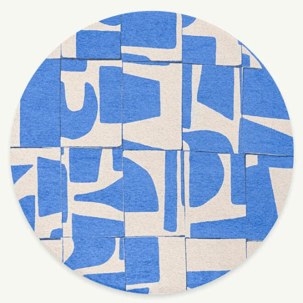 Round luxury Louis De Poortere Papercut rug with abstract blue and white geometric pattern