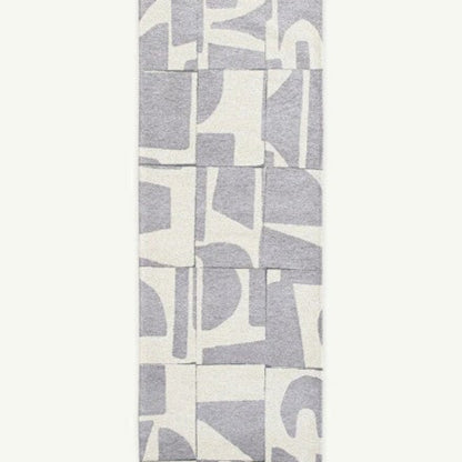 Louis De Poortere Papercut rug luxury design with grey abstract shapes on white background 