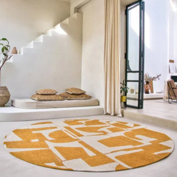 Round luxury Louis De Poortere Papercut rug with abstract yellow and white geometric design in modern living space
