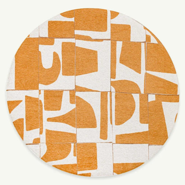 Round luxury Louis De Poortere Papercut rug with abstract orange and white geometric design