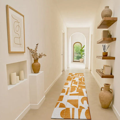 Louis De Poortere Papercut rug with abstract orange and white pattern in a bright modern hallway
