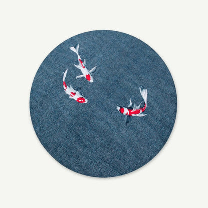 Round Louis De Poortere Pop rug with blue base and three red white koi fish design