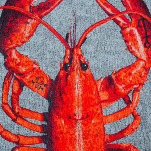 Close-up of Louis De Poortere Pop rug featuring a bright orange lobster design on a grey background