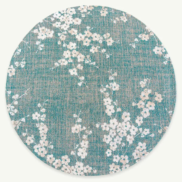 Round luxury Louis De Poortere Sakura rug with delicate white floral pattern on teal background