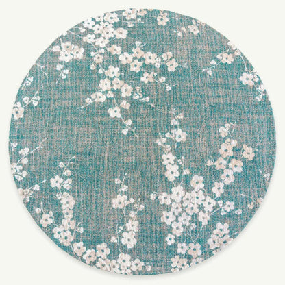 Round luxury Louis De Poortere Sakura rug with delicate white floral pattern on teal background
