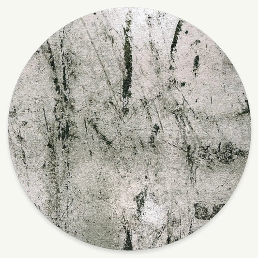 Louis De Poortere Sol rug in circular shape with a textured grey abstract design