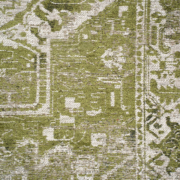 Close-up of a green and cream patterned Louis De Poortere Tabriz rug showcasing intricate luxurious design