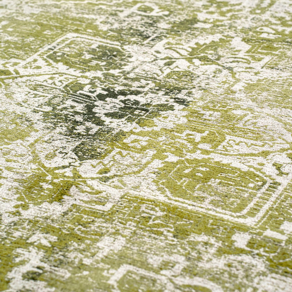 Close-up of green patterned Louis De Poortere Tabriz rug showcasing intricate traditional design details