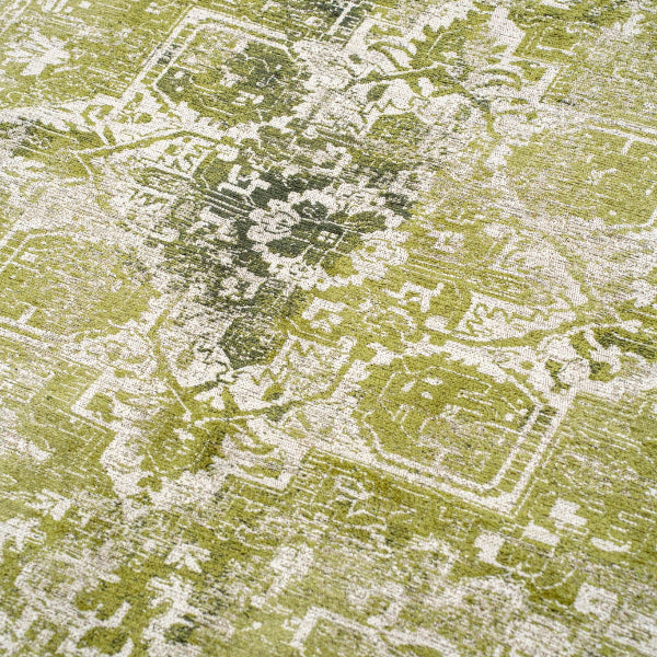 Close-up of Louis De Poortere Tabriz rug in green with intricate floral and geometric patterns