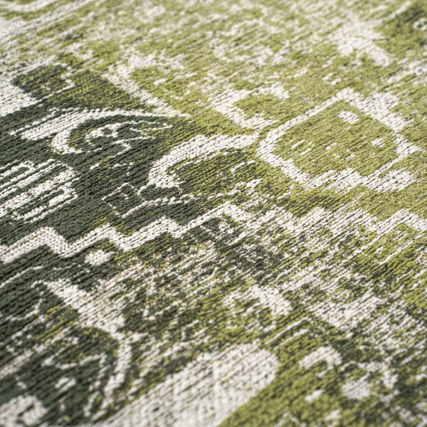 Close-up of Louis De Poortere Tabriz rug showing detailed green and white woven patterns