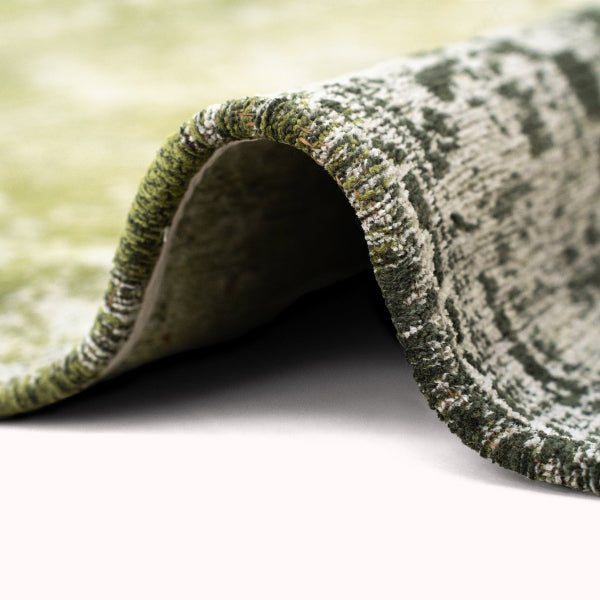 Close-up of green patterned luxury Louis De Poortere Tabriz rug showing texture and intricate design