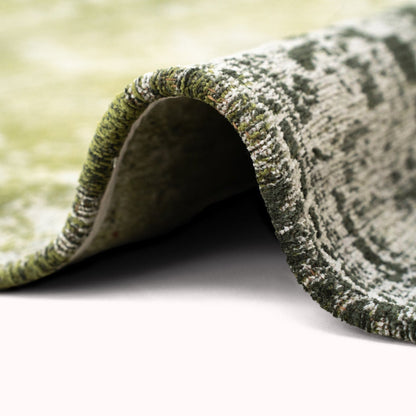 Close-up of green patterned luxury Louis De Poortere Tabriz rug showing texture and intricate design