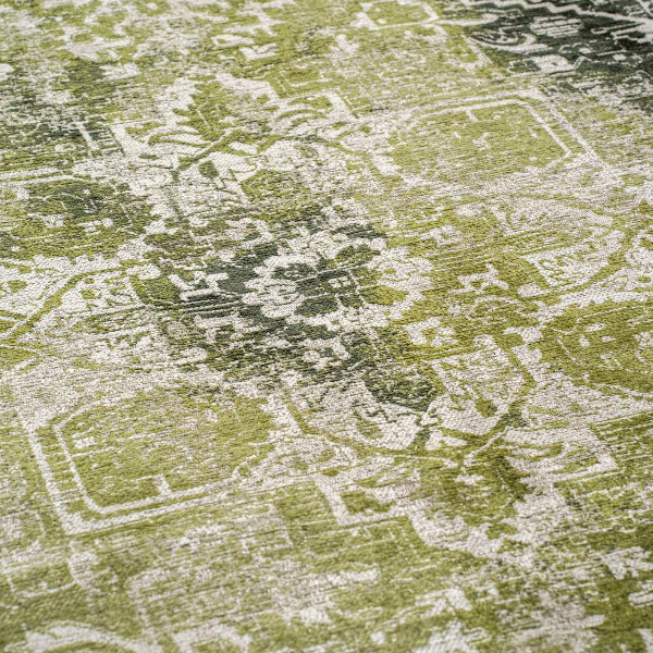 Close-up of green and white intricate pattern on a Louis De Poortere Tabriz rug luxury floor covering