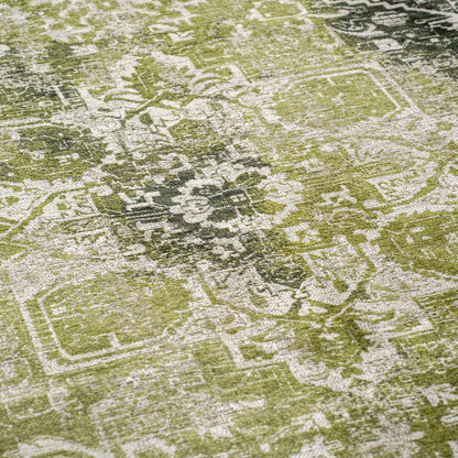 Close-up of green and white intricate pattern on a Louis De Poortere Tabriz rug luxury floor covering