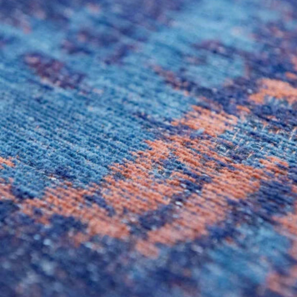 Close-up of Louis De Poortere Venetian Dust rug showing detailed blue and orange luxury textured fibres
