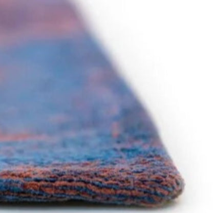 Close-up view of the edge of a Louis De Poortere Venetian Dust rug showcasing its detailed woven texture