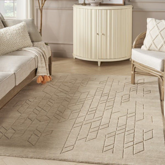 Beige Nourison Alessia rug with geometric pattern in a modern living room setting