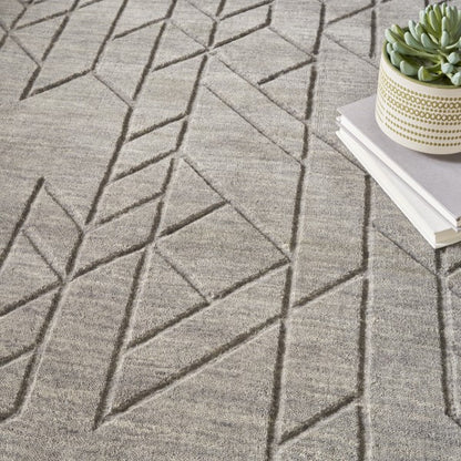 Nourison Alessia rug in neutral tones with geometric textured pattern and decorative plant on top