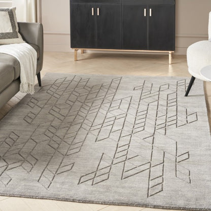 Luxury grey Nourison Alessia rug with geometric pattern in modern living room setting