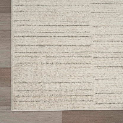 Luxury beige and grey textured Nourison Andes Rug Collection on wooden floor corner