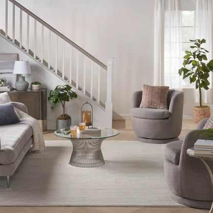 Nourison Andes Rug Collection luxury rug in modern living room with grey chairs and glass coffee table