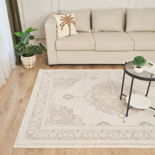 Olivia Contemporary Rug Collection in Beige featuring intricate patterns, placed under a stylish coffee table