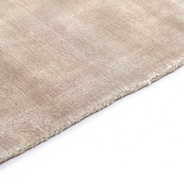 Close-up of a beige rug corner on a white background