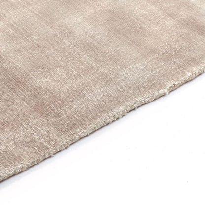 Close-up of a beige rug corner on a white background