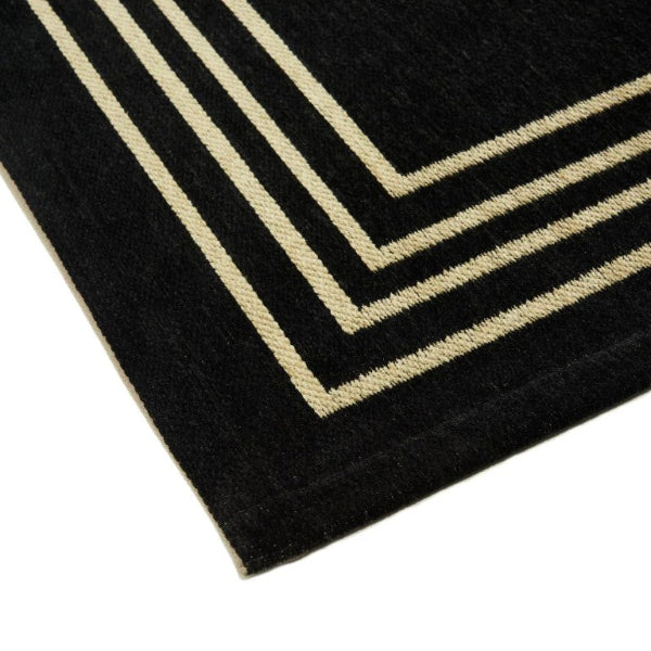 Black rug with beige stripes on a white background