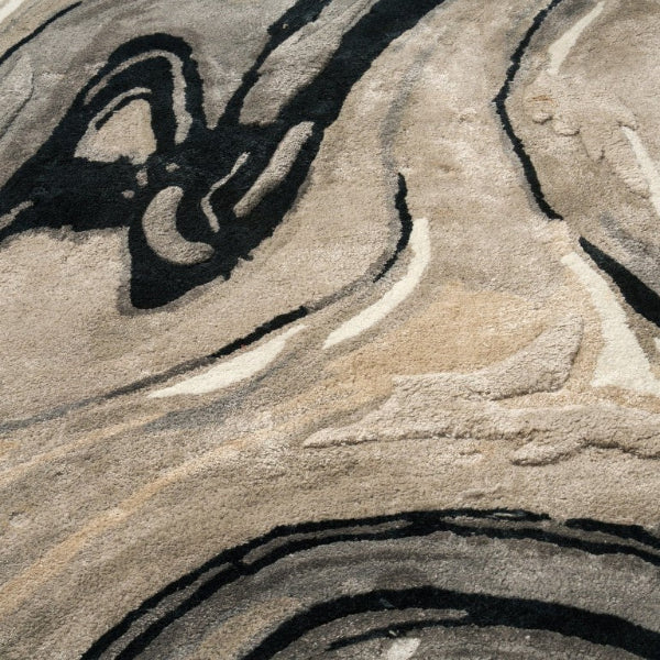 Close-up of a textured surface with wavy patterns in beige, brown, and black.