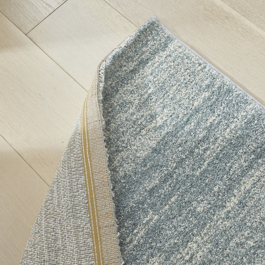 Gray textured rug on a wooden floor