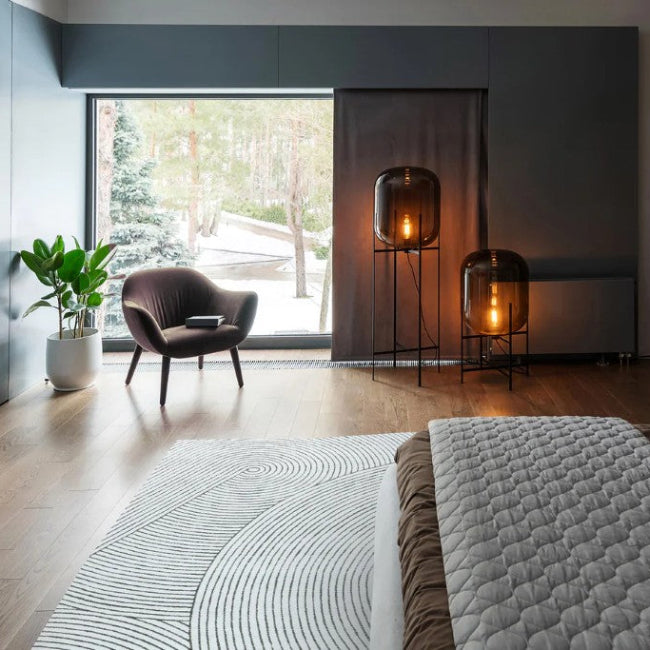 Modern bedroom with a bed, television, and decorative items.