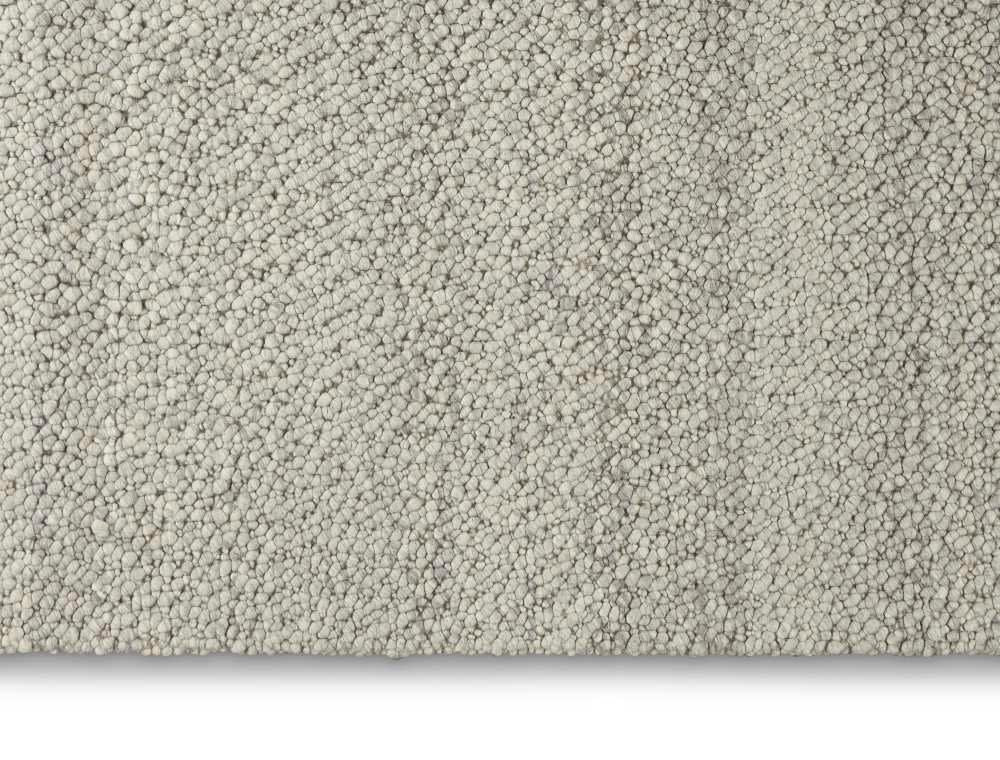 The Calvin Klein Riverstone Rug Collection in soft grey texture, perfect for luxury home interiors
