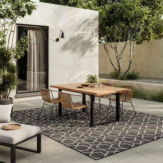 The Horizon Outdoor Rug Collection enhancing a stylish patio with modern furniture and greenery