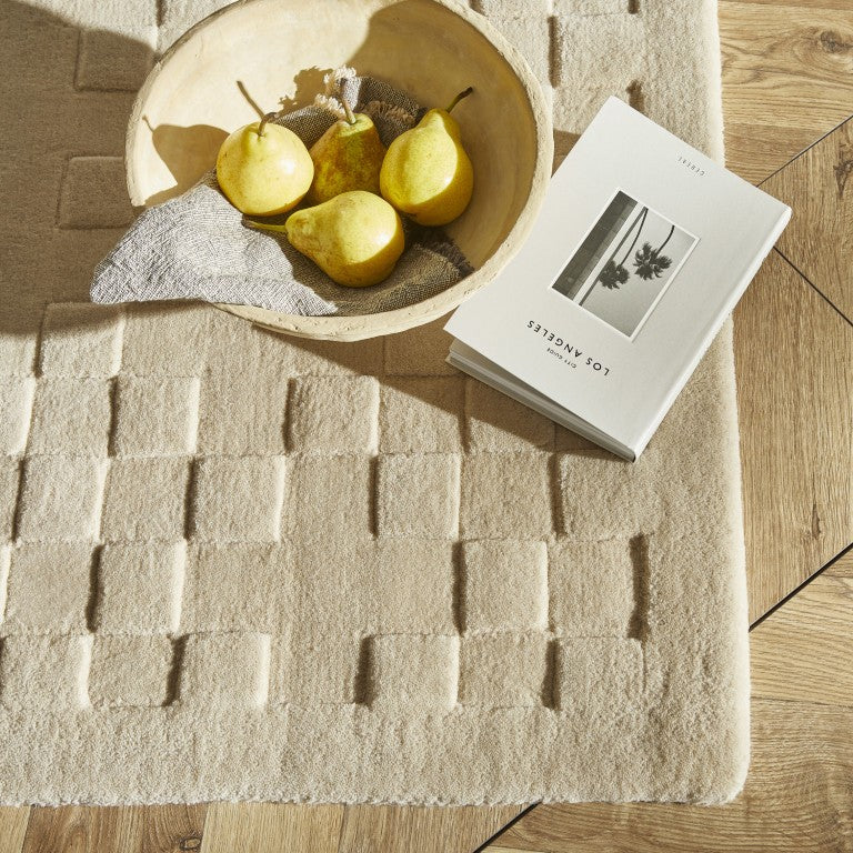 The Priory Wool Collection luxury rug in neutral tones, featuring a textured geometric design with natural decor