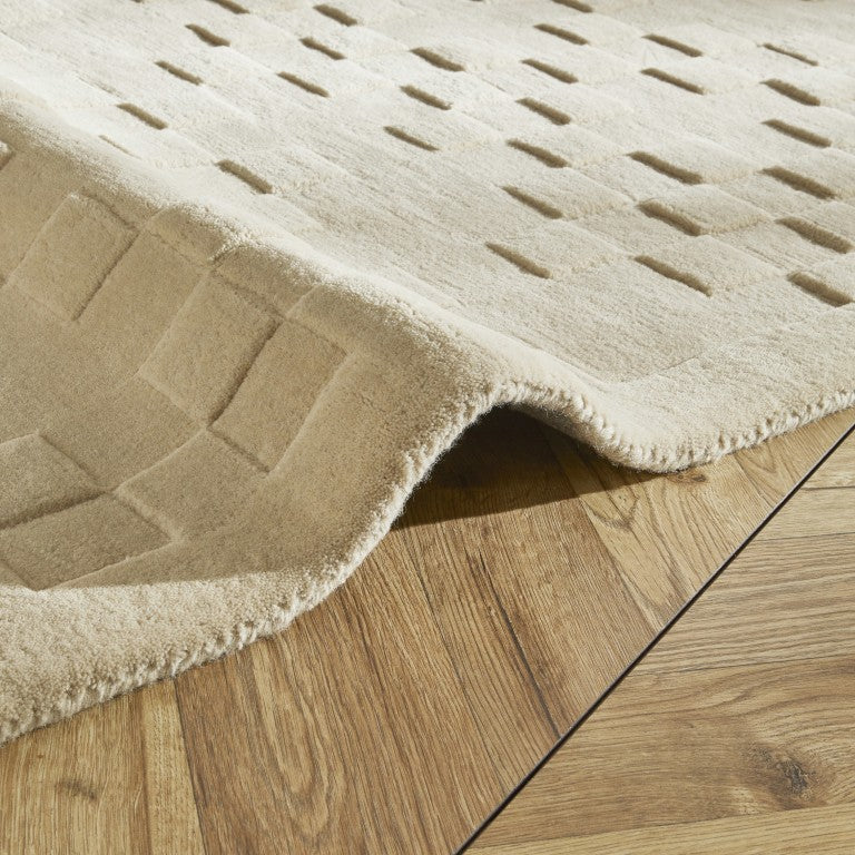 Luxury rug from The Priory Wool Collection with a textured finish in a neutral colour on wooden flooring